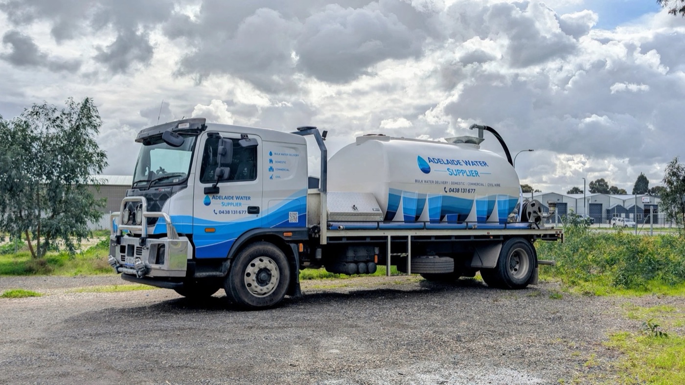 One of your liveried water trucks, side on, under a cloudy sky